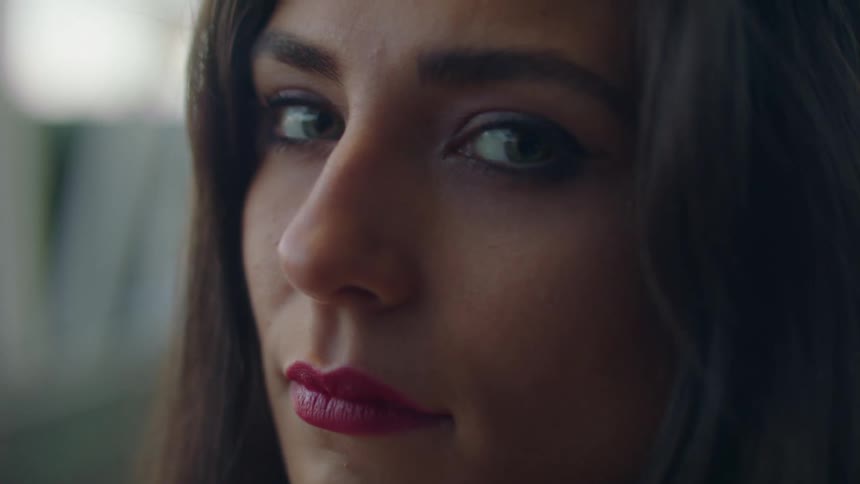 A woman with lipstick staring