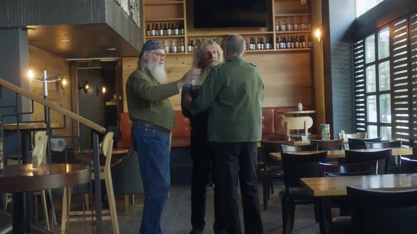 Elderly men with long beards and hairs meet up in the pub