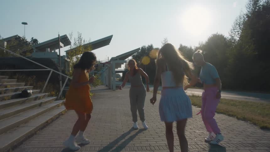 A group of young women are doing a popular dance on the street