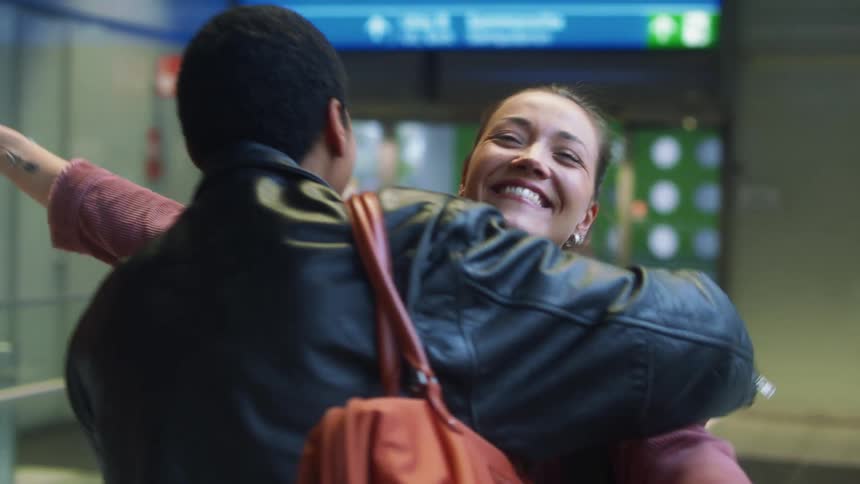 A group of people all meeting laughing and smiling