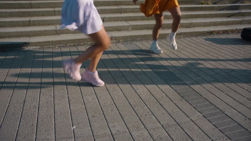 A group of women dancing by a road