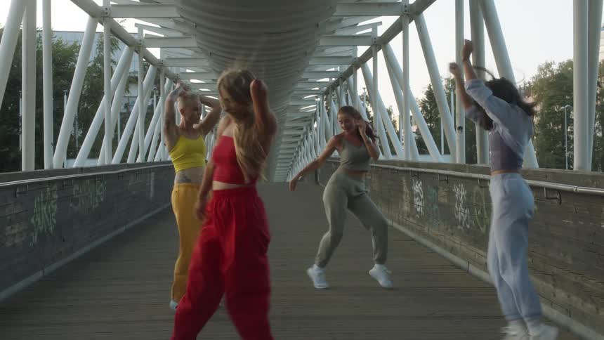 A group of people dancing on a bridge
