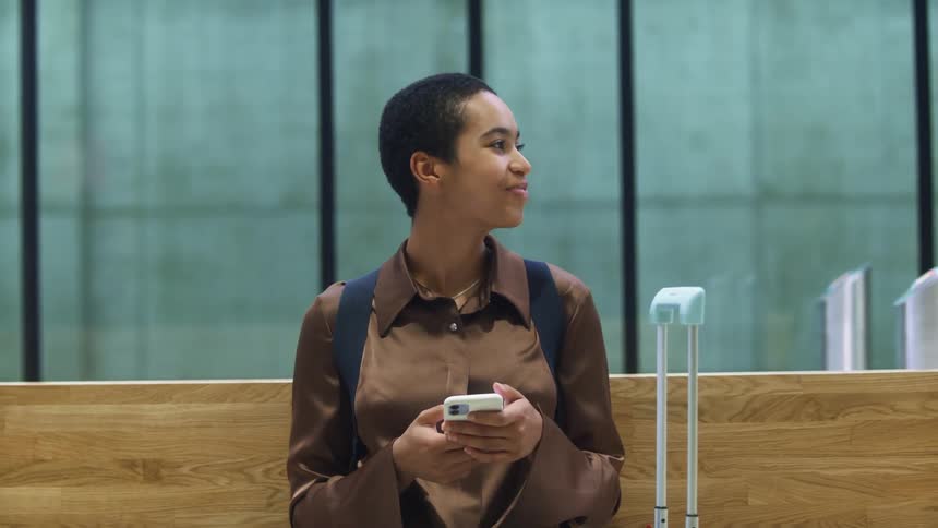 A woman smiles as she looks in the distance then gets up to walk away