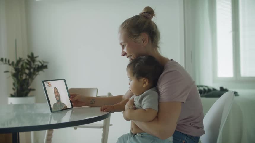 A family talking on a tablet in a room