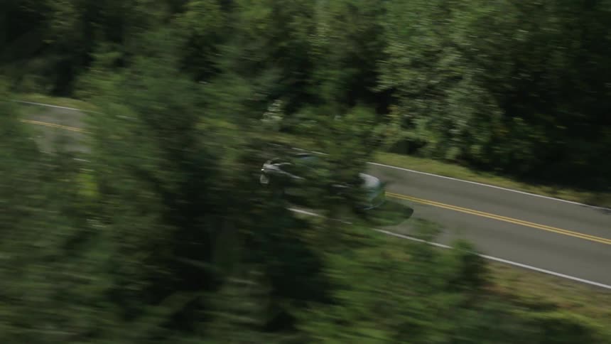 A car travels down a road below
