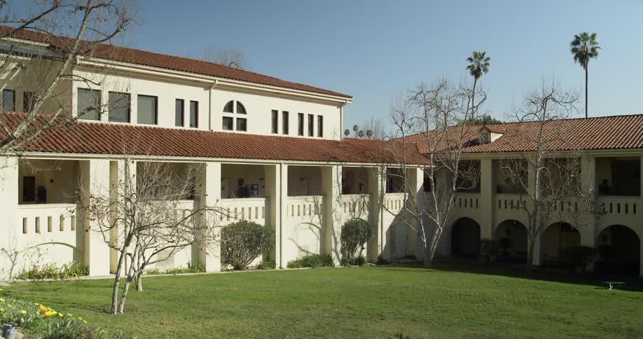 A look at walls of a large house with lush green lawn