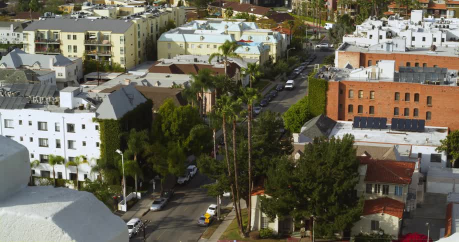 View of city apartments and roads with palm trees