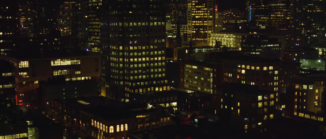 The buildings are brightly lit at night