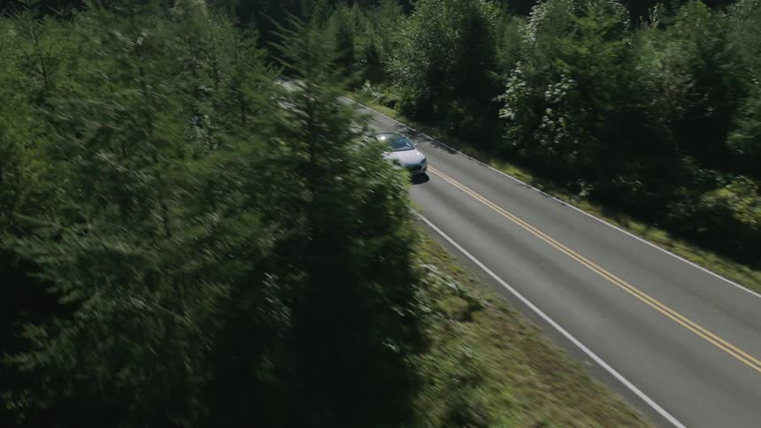 Aerial view of a car traveling down a road