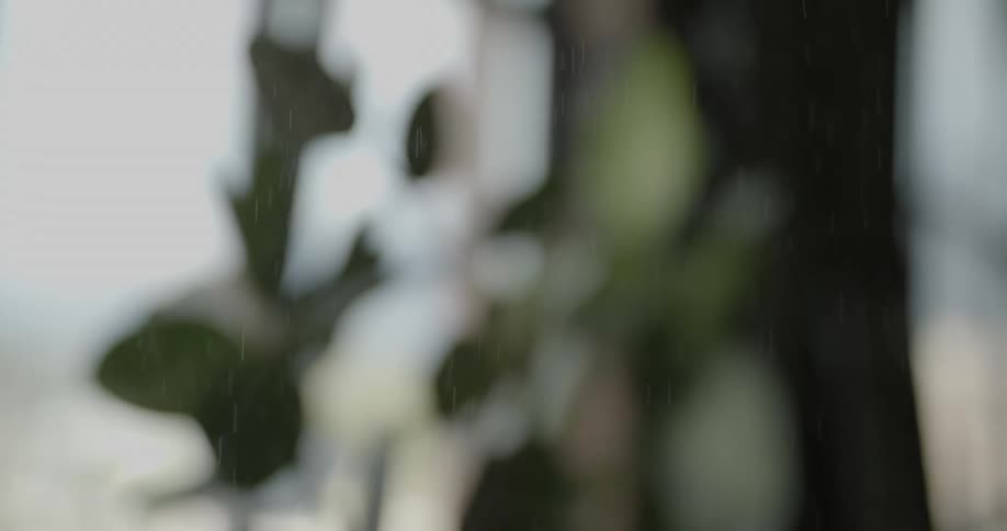 Droplets fall down behind the blurry image