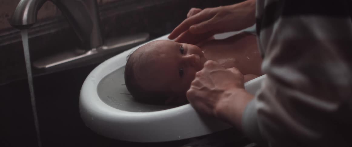 A baby laying in a diaper change device