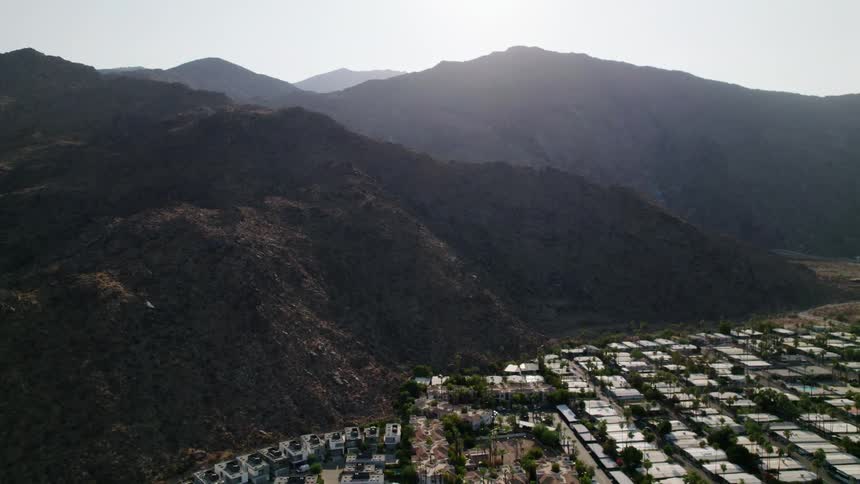 Aerial view of a small town near the mountains in the morning