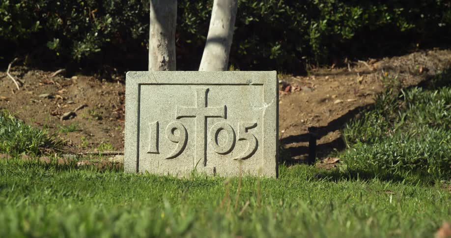 A stone has a carving of a cross on it