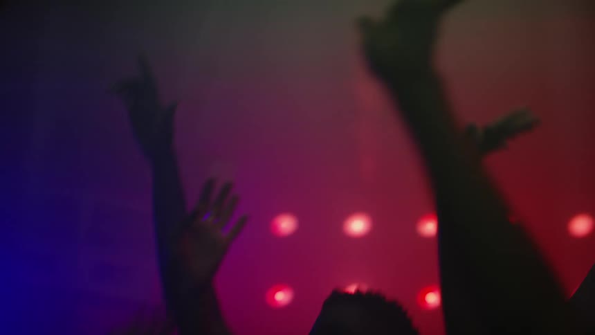 People dancing indoors under bright lights