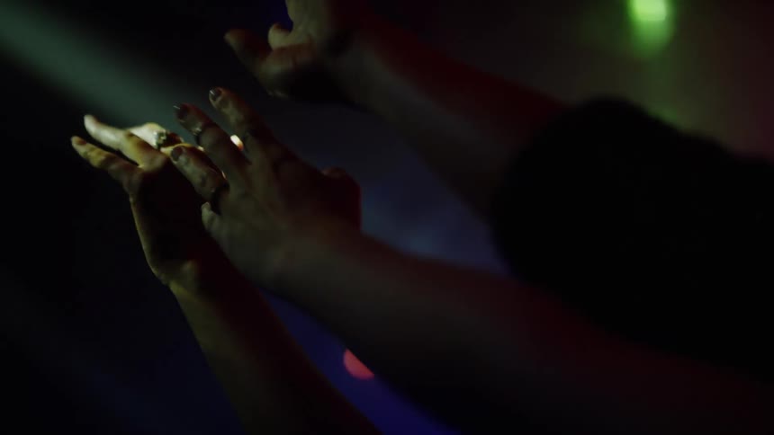 People are waving their hands high in the club