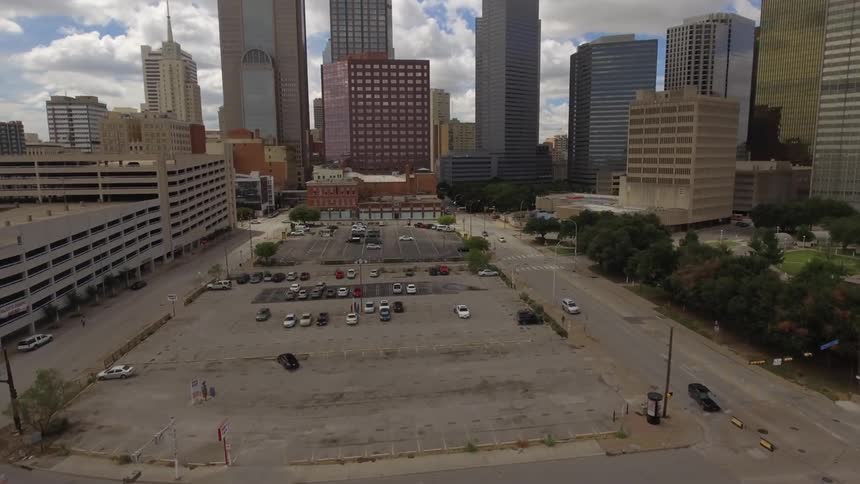 Time-lapse aerial footage of traffic travelling through the downtown area of a large city