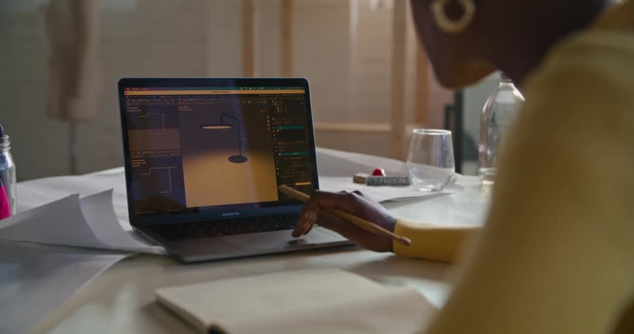 A woman is looking at a diagram on her laptop while talking