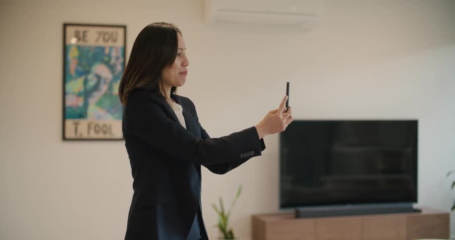 A woman is showcasing a property with cellphone through videocall