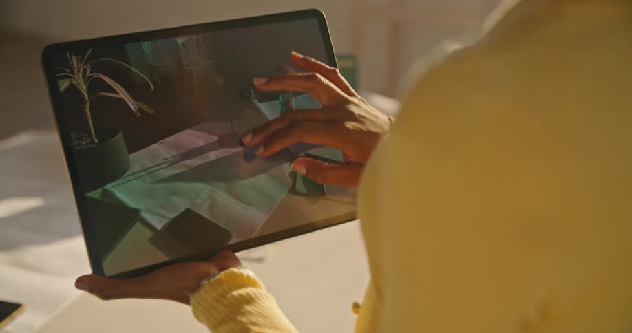 Woman with yellow sweater uses tablet with augmented reality