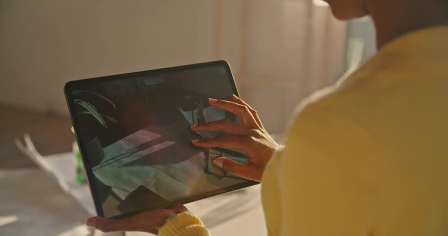 A woman is using a tablet in the office