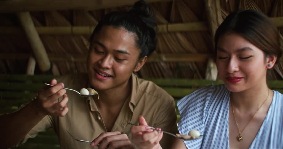 A man and woman eat a meal together