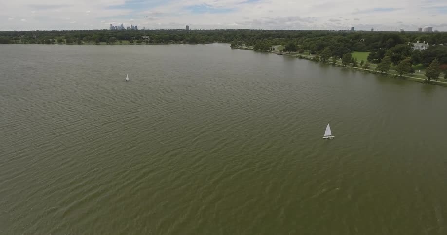 Sailboats travelling across a lake