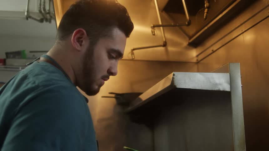 A man using a fryer in a restaurant