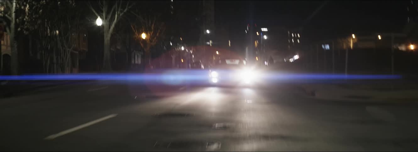 A view of a car driving down a road