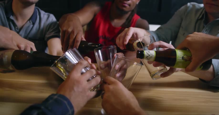 People fill their glasses with beer in the bar