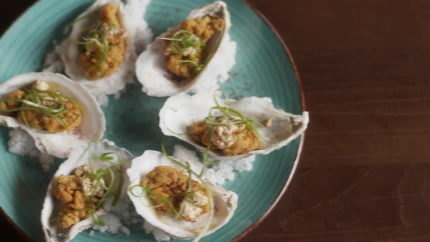 The dish has baked oysters on rice
