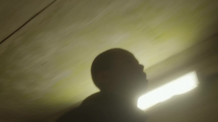 Young man wearing sports clothes jogging inside a tunnel