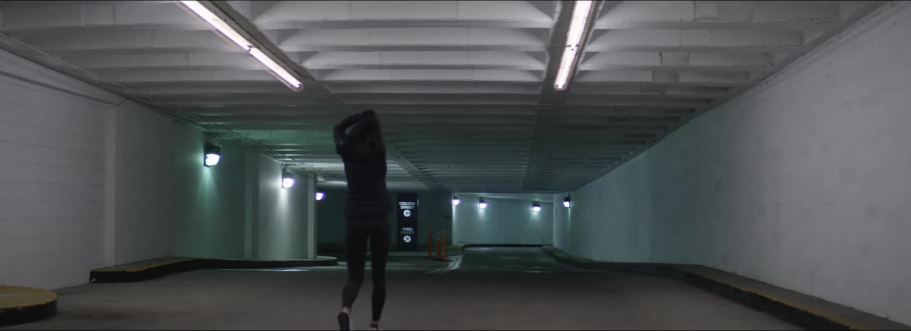 A woman walking in a parking garage