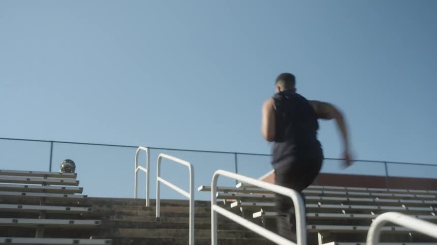A man races up the concrete steps