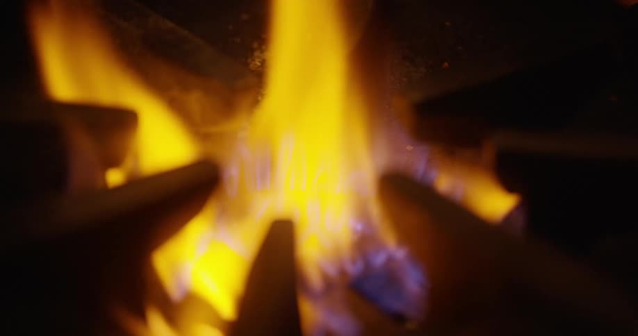 A flame burning on a gas stove burner