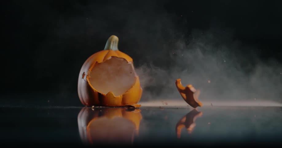 The face of a jack o lantern flies off in an explosion