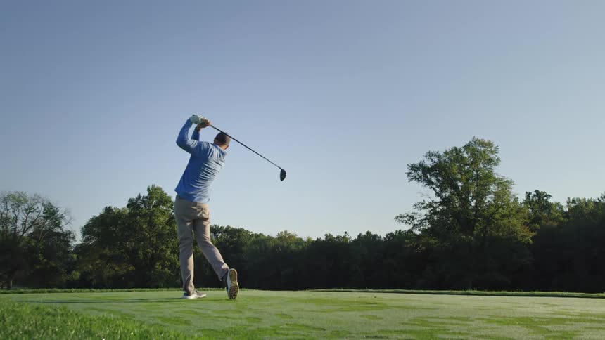 A man playing golf outdoors