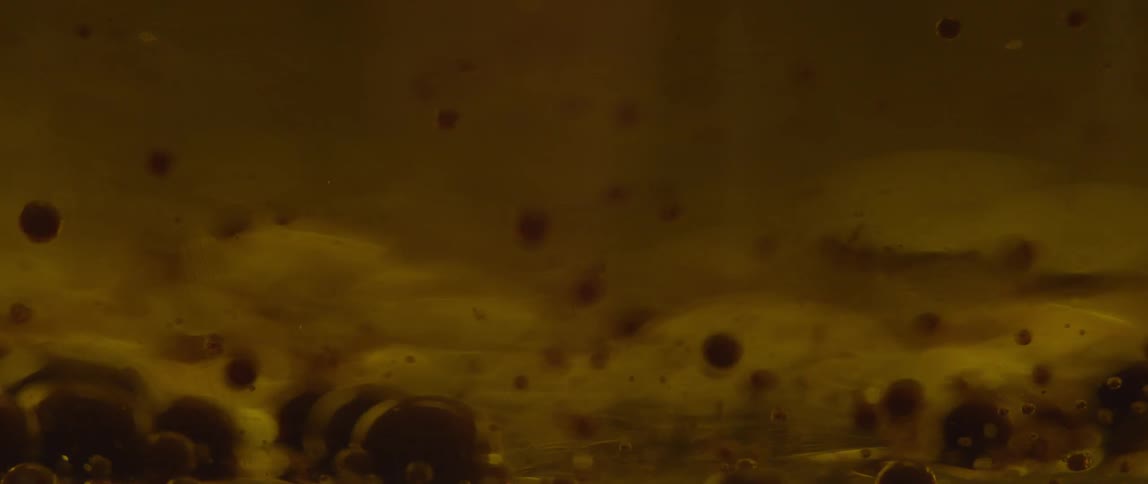 Small bubbles float to the bottom of this liquid
