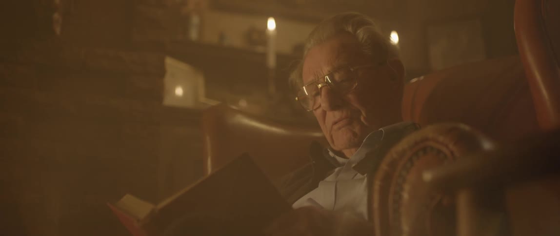 A man is sitting and reading out loud