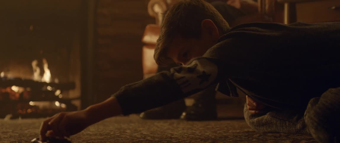 Boy pushes his toy car in circles on the carpet