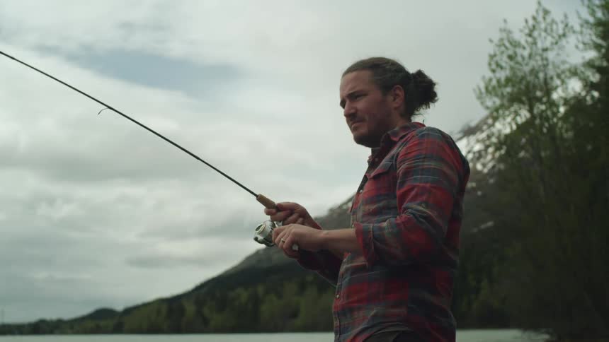 A man that is fishing outdoors