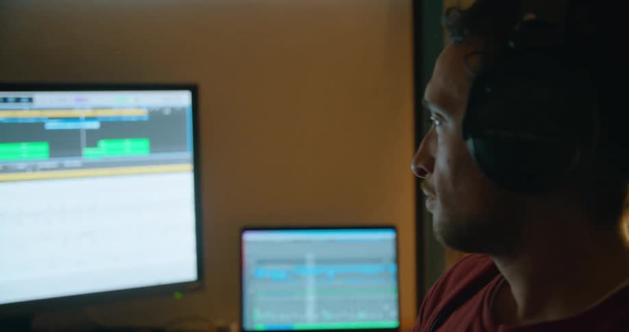 A man is nodding his head as he looks at a computer screen