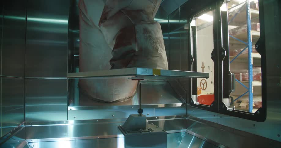 A large object is being printed in a metal room