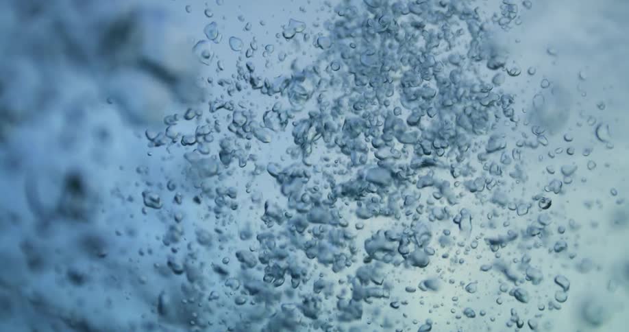 Bubbles rising up to an undulating surface