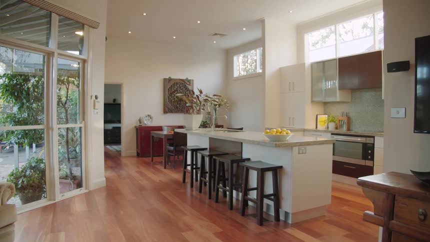 A home interior featuring a living room kitchen and external patio in the daytime