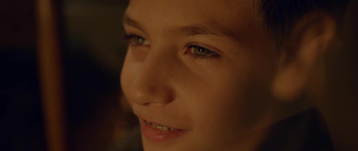 A kid wearing braces smiles