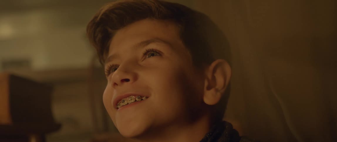 A boy looks up smiling