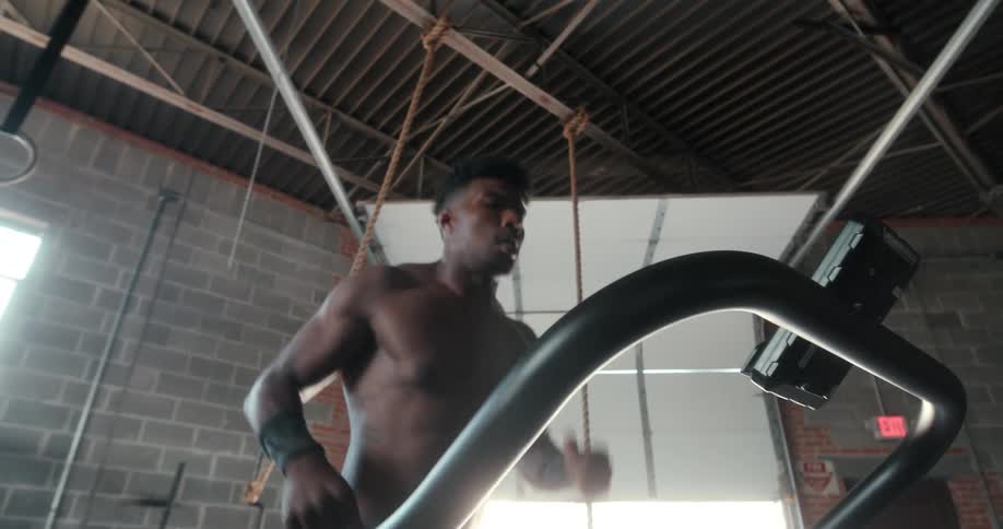 A man runs on a treadmill indoors