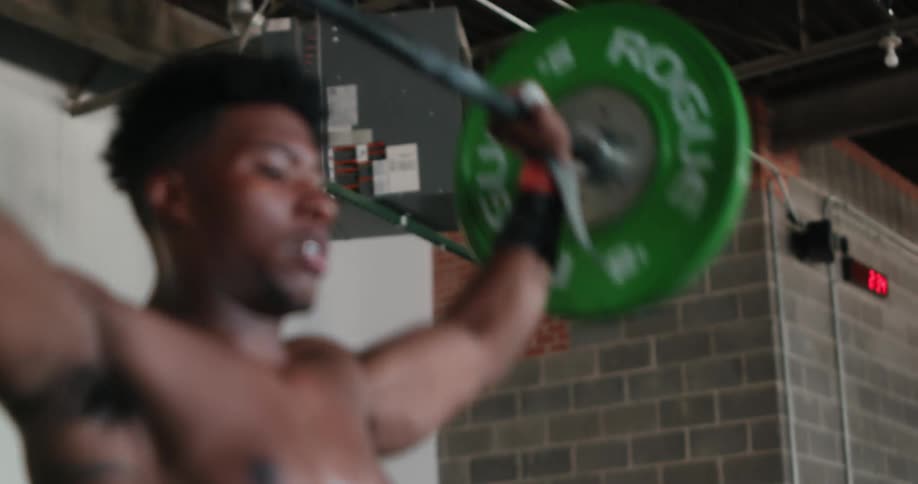 Man lifts weights in gym