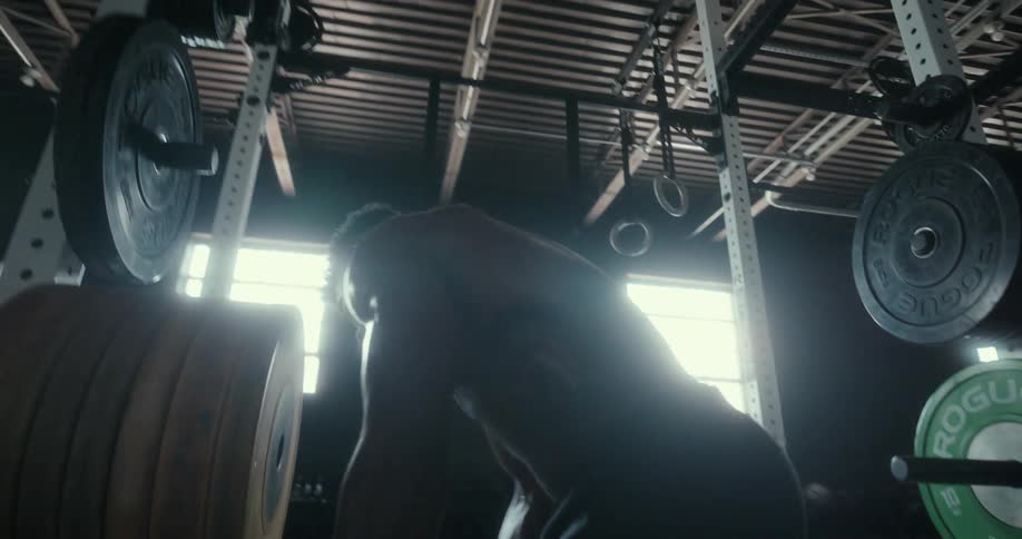 A man adds more weight onto a machine at the gym
