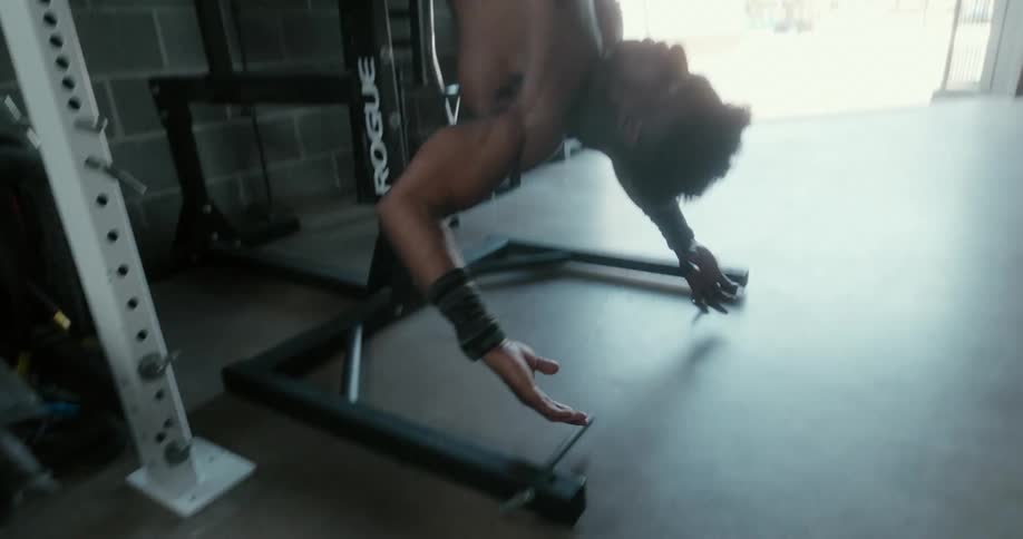 Strong shirtless muscular man working out on a gym